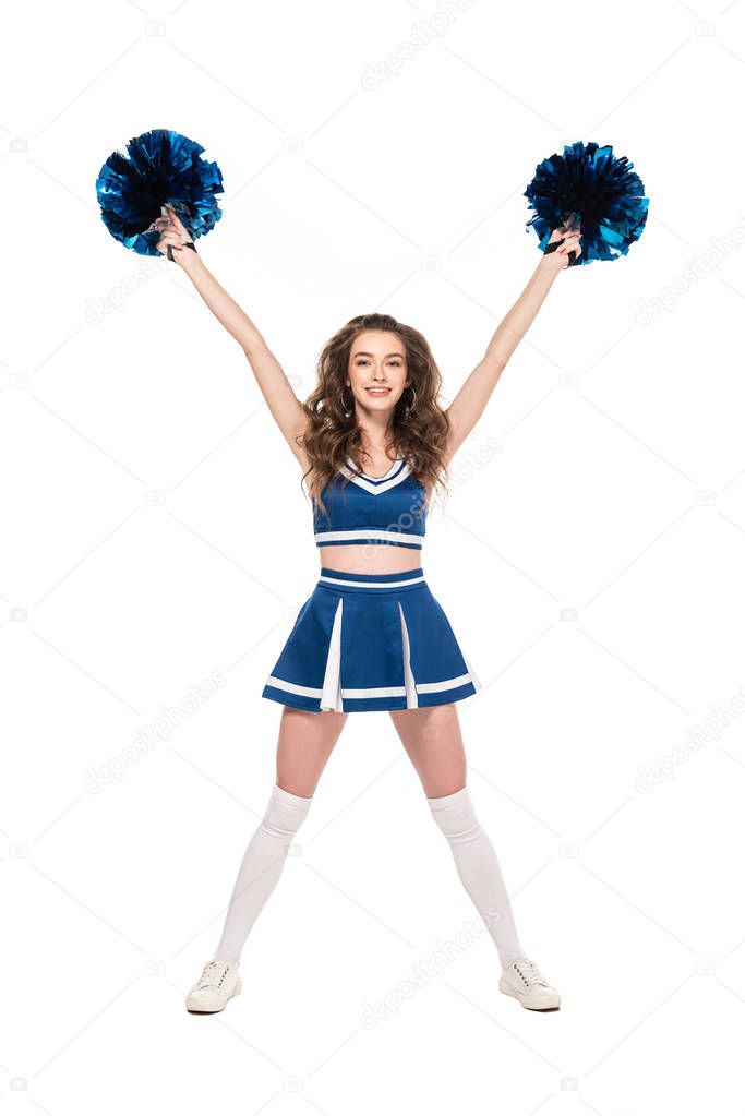 full length view of smiling cheerleader girl in blue uniform dancing with pompoms isolated on white
