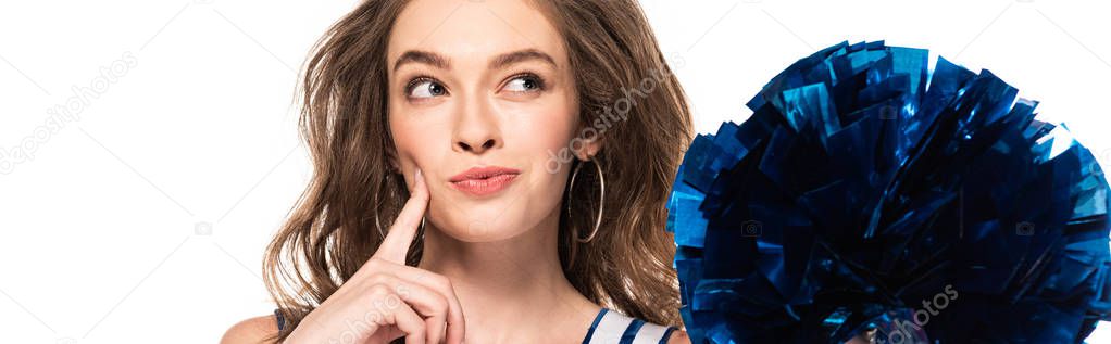 dreamy cheerleader girl in blue uniform holding pompom and looking away isolated on white, panoramic shot