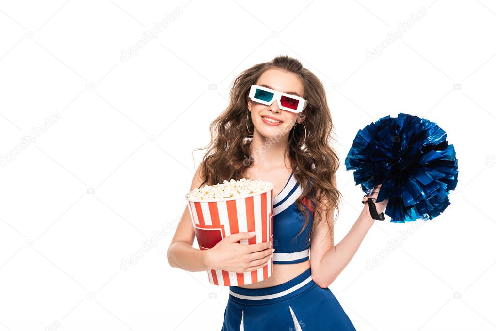 smiling cheerleader girl in blue uniform and 3d glasses with pompom and bucket of popcorn isolated on white