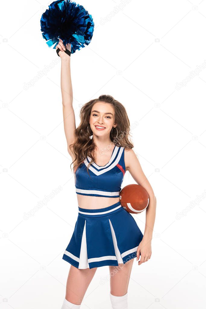 happy cheerleader girl in blue uniform holding rugby ball and pompom isolated on white
