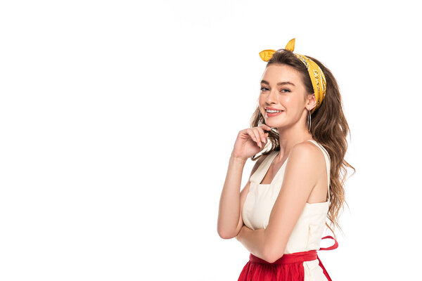 happy young housewife in dress and apron posing isolated on white