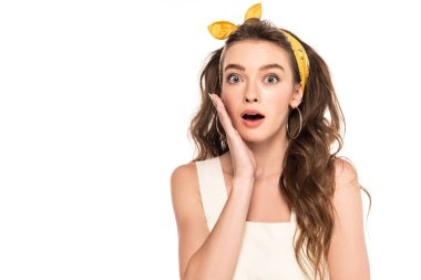 young shocked housewife in dress and headband looking at camera isolated on white clipart