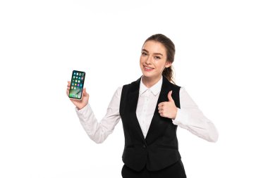 Kiev, Ukrayna - 7 Nisan 2019: mutlu genç garson iphone tutan ve beyaz izole başparmak gösteren