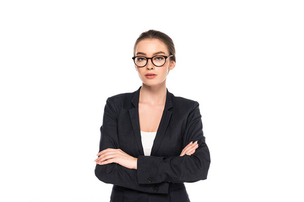 young successful businesswoman in black suit and glasses with crossed arms isolated on white