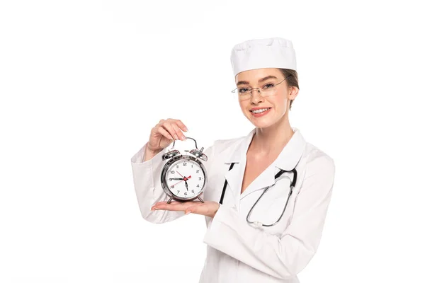 Young Doctor White Coat Stethoscope Showing Silver Alarm Clock Isolated — Stock Photo, Image