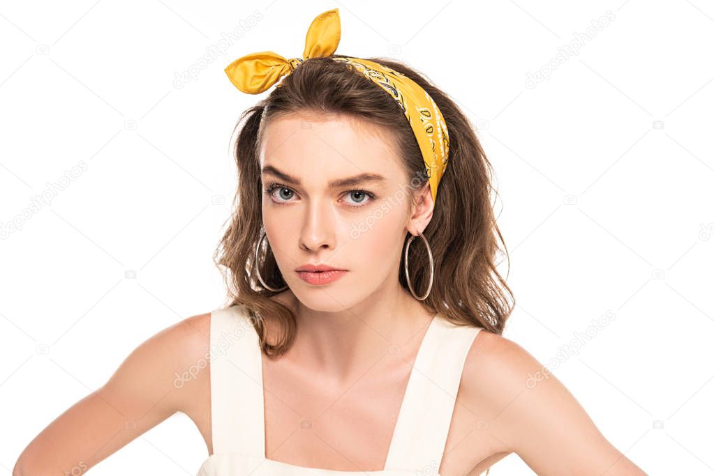 young angry housewife in dress and headband looking at camera isolated on white