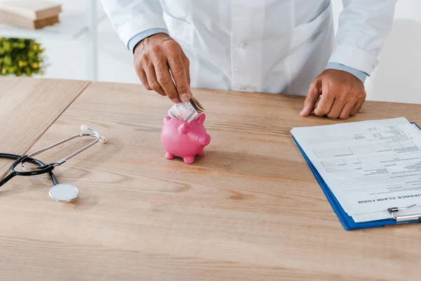 Cropped View Man White Coat Putting Dollar Banknote Piggy Bank — Stock Photo, Image