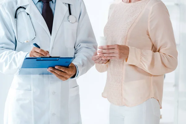 Cropped View Man Holding Clipboard Pen While Writing Diagnosis Woman — Stock Photo, Image