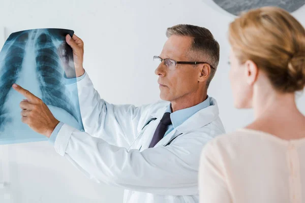 Selective Focus Serious Doctor Glasses Pointing Finger Ray Woman — Stock Photo, Image