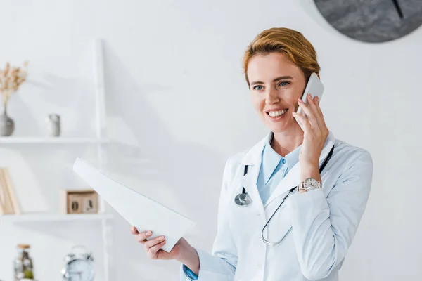 Cheerful Doctor Holding Paper Smiling While Talking Smartphone — Stock Photo, Image
