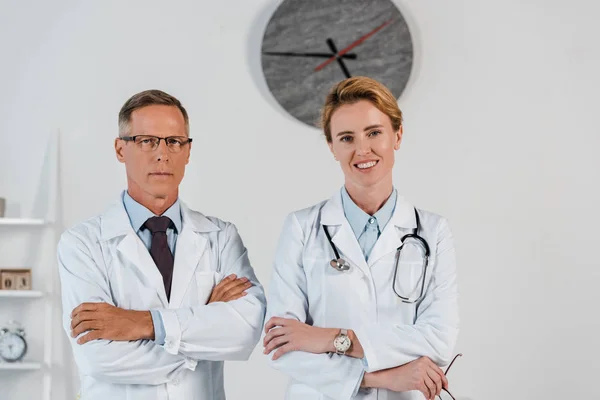 Handsome Doctor Standing Crossed Arms Cheerful Colleague Clinic — Stock Photo, Image