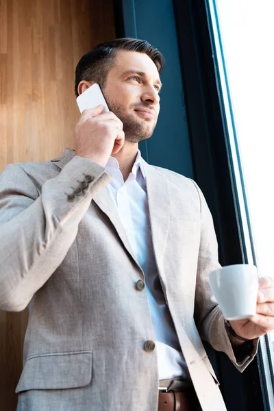 Smiling Businessman Holding Cup Coffee Talking Smartphone Cafe — Stock Photo, Image