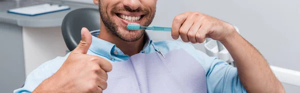 Panoramic Shot Bearded Man Showing Thumb While Holding Toothbrush — Stock Photo, Image