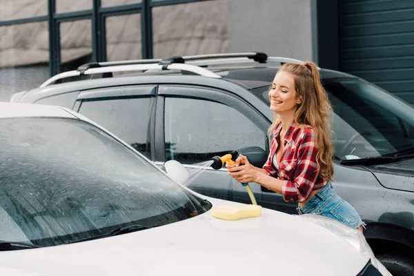 Mujer Atractiva Feliz Pantalones Cortos Mezclilla Sonriendo Mientras Lava Auto —  Fotos de Stock