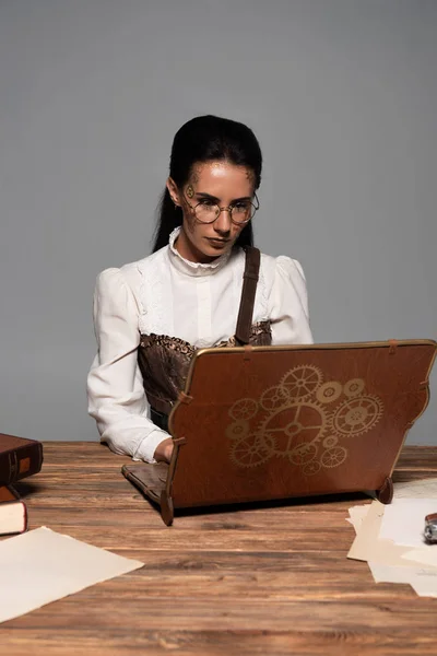 Focused Steampunk Woman Using Vintage Laptop Workplace Isolated Grey — Stock Photo, Image