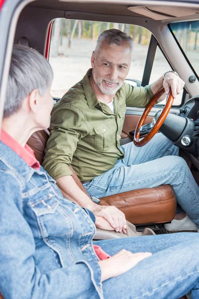 Senior Couple Looking Each Other Holding Hands While Sitting Car — Stock Photo, Image