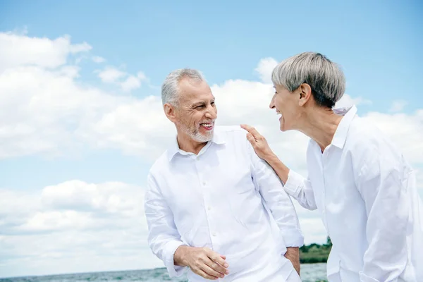 Happy Smiling Senior Couple White Shirts Looking Each Other Blue — Stock Photo, Image