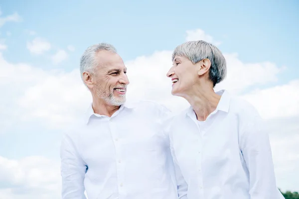 Feliz Sonriente Pareja Ancianos Camisas Blancas Mirándose Bajo Cielo Azul — Foto de Stock