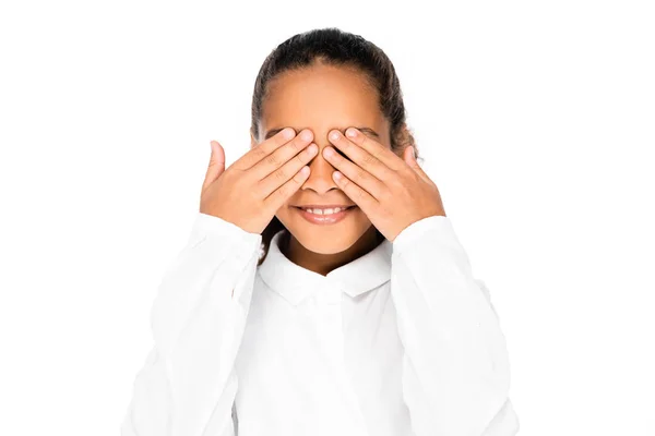 Cheerful African Schoolgirl Smiling While Covering Eyes Hands Isolated White — Stock Photo, Image