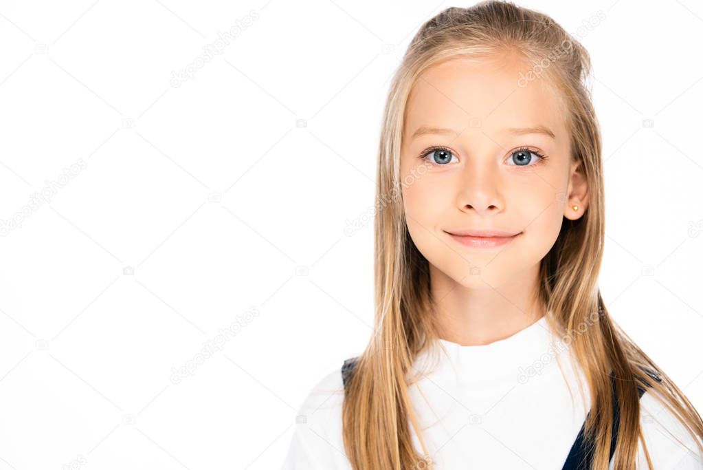 adorable smiling schoolgirl smiling at camera isolated on white with copy space