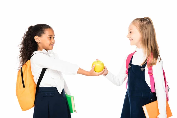 Vrolijke African American Schoolmeisje Geeft Apple Aan Vriend Geïsoleerd Wit — Stockfoto