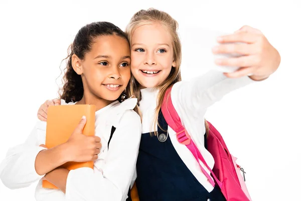 Happy Schoolgirl Taking Selfie While Hugging African American Friend Isolated — Stock Photo, Image