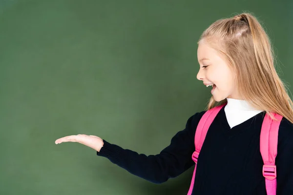 Cheerful Schoolgirl Pointing Hand Green Chalk Board — Stock Photo, Image