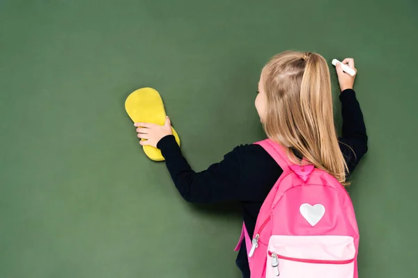 Back View Schoolgirl Wiping Chalkboard Sponge While Holding Piece Chalk — Stock Photo, Image
