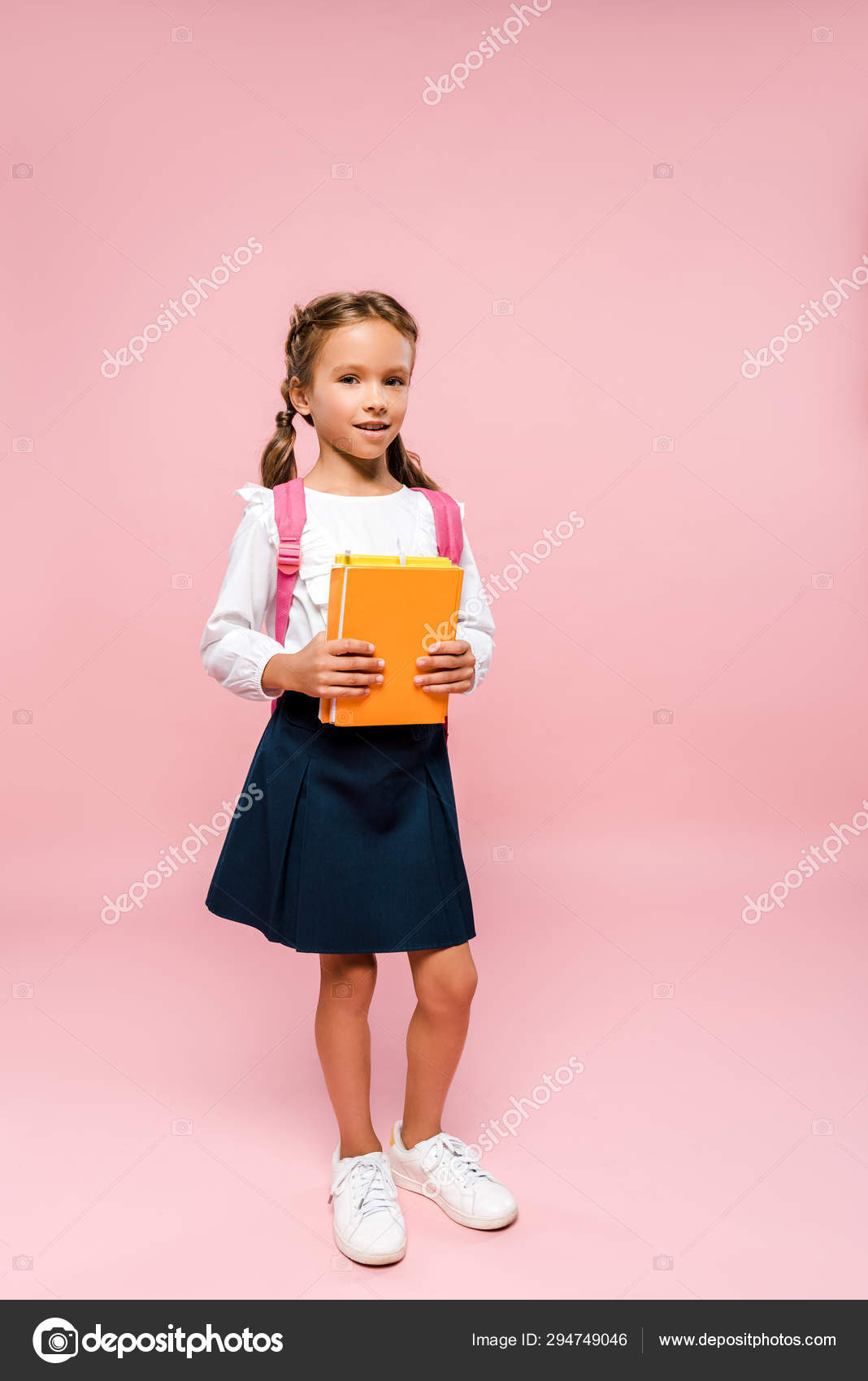 kid holding backpack