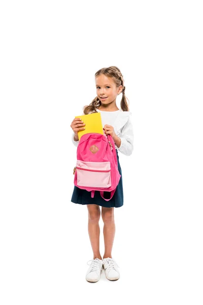 Happy Child Putting Book Pink Backpack While Standing Isolated White — Stock Photo, Image