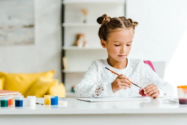 Cute Kid Holding Paintbrush Gouache Jars Table — Stock Photo, Image