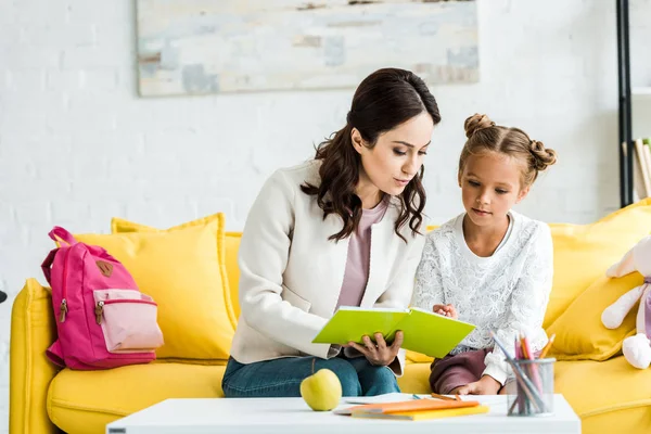 Attractive Mother Reading Book Cute Daughter Home — Stock Photo, Image