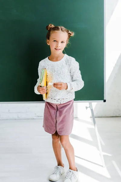 Happy Kid Holding Book Green Chalkboard — Stock Photo, Image