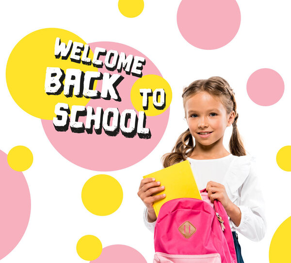 smiling child putting book in pink backpack near back to school lettering on white 