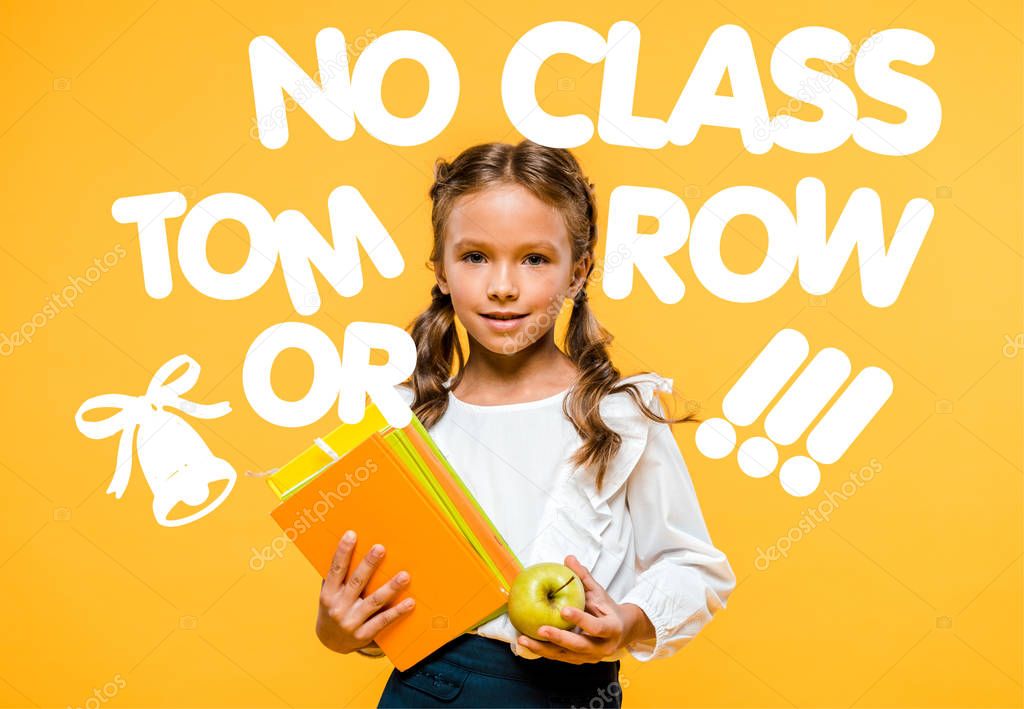 happy schoolchild holding tasty apple and books near no class tomorrow lettering on orange 