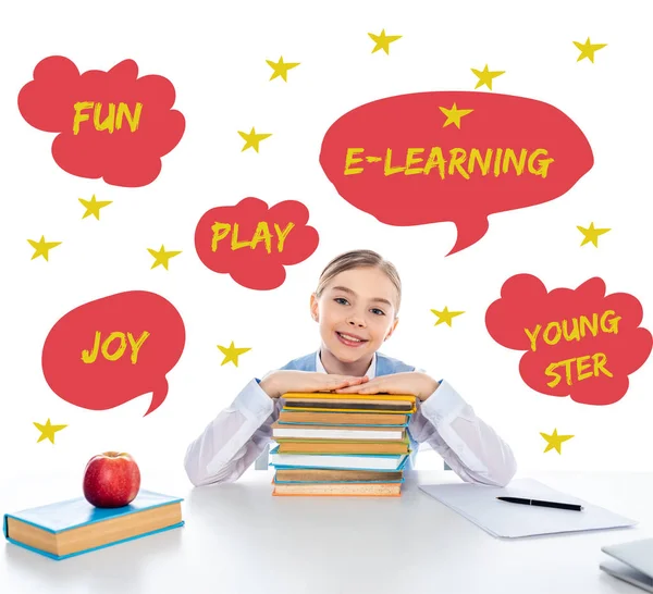 Smiling Schoolgirl Sitting Desk Books Looking Camera Speech Bubbles Letters — Stock Photo, Image