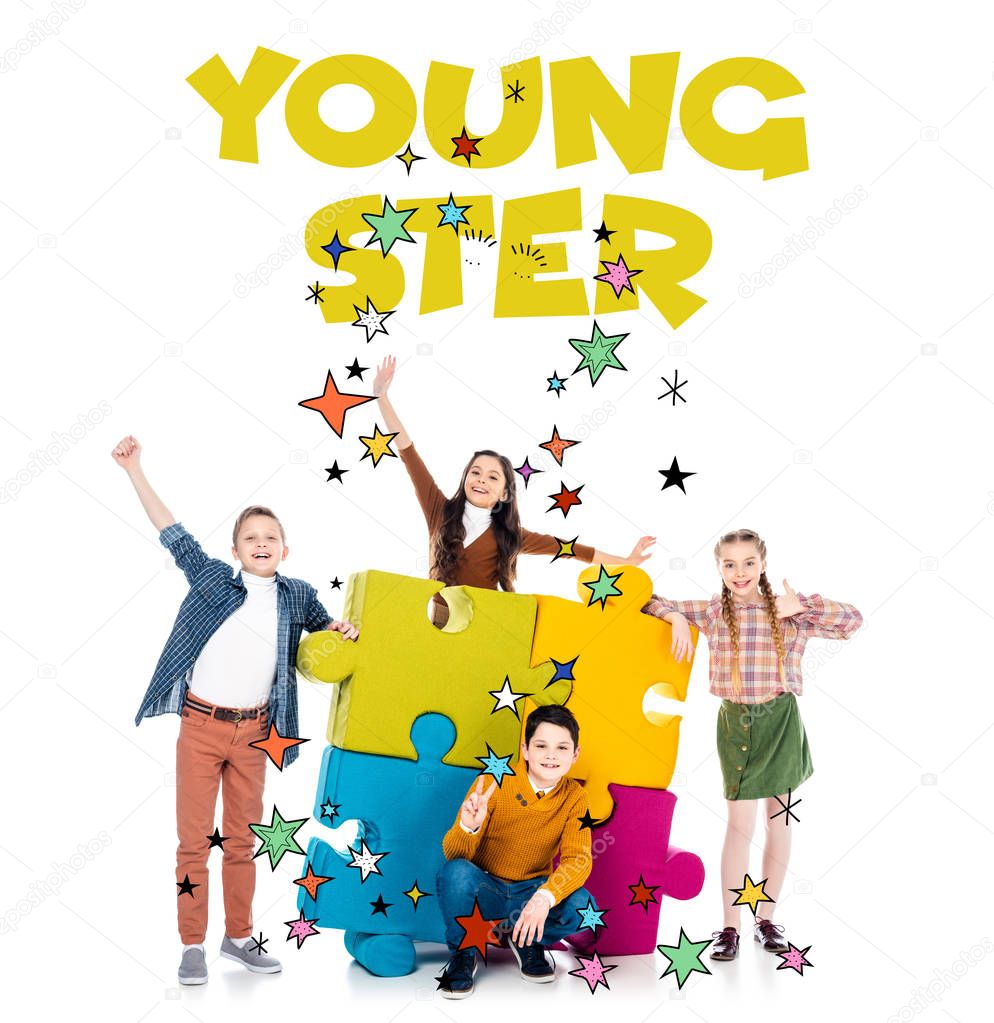 cheerful kids near colorful jigsaw puzzle pieces and youngster letters on white