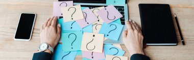 panoramic shot of woman near sticky notes with question marks on laptop  clipart