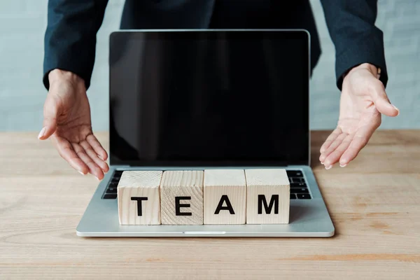 Cropped View Woman Gesturing Laptop Blank Screen Cubes Team Letters — Stock Photo, Image