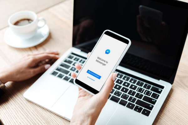 KYIV, UKRAINE - AUGUST 5, 2019: cropped view of woman holding smartphone with messenger app 
