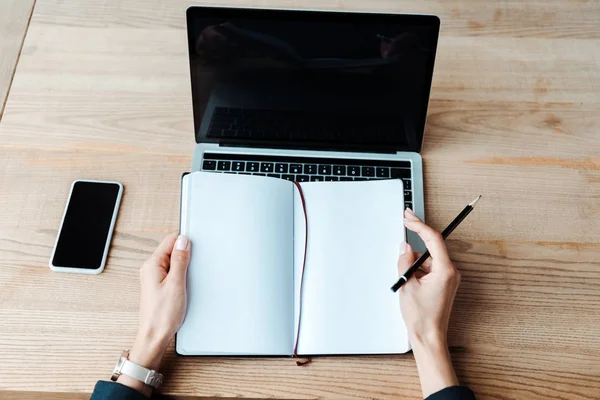 Top Uitzicht Van Vrouw Houden Notebook Buurt Van Laptop Smartphone — Stockfoto