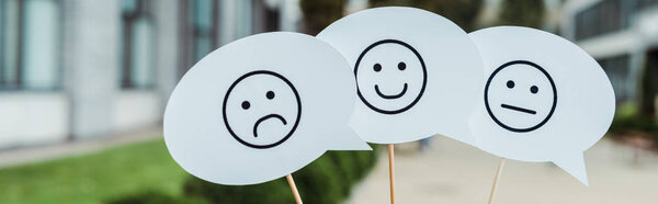 KYIV, UKRAINE - AUGUST 5, 2019: panoramic shot of set with emoticons on speech bubbles and sticks 