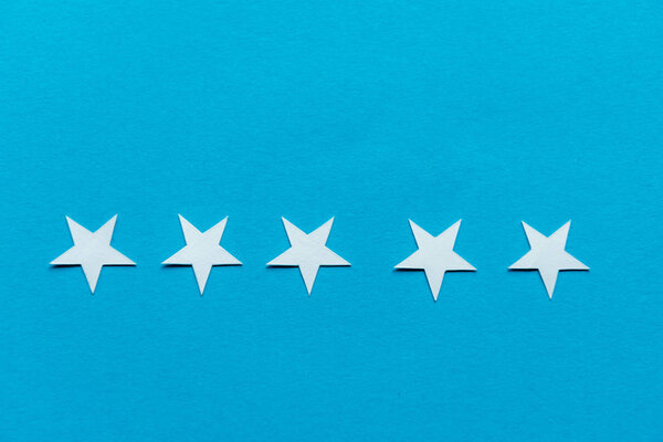 top view of white stars isolated on blue 