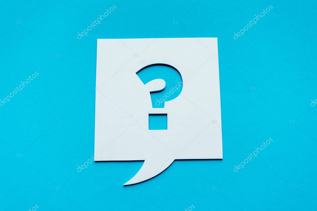 top view of question mark on white speech bubble isolated on blue 