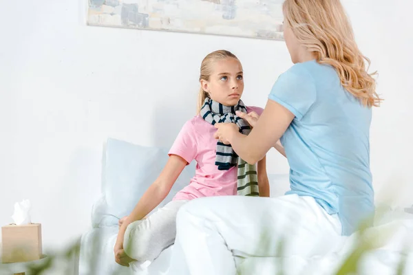 Selective Focus Mother Touching Striped Scarf Sick Daughter — Stock Photo, Image