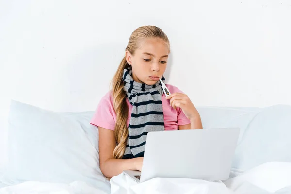 Sick Kid Holding Digital Thermometer Mouth Looking Laptop — Stock Photo, Image