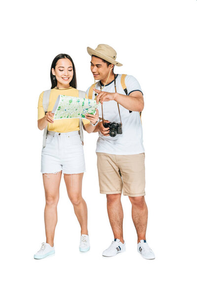 handsome asian man pointing with finger while looking at map with girlfriend on white background