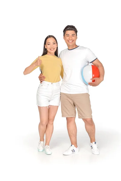 Happy Asian Man Holding Beach Ball Hugging Girlfriend Showing Thumb — Stock Photo, Image