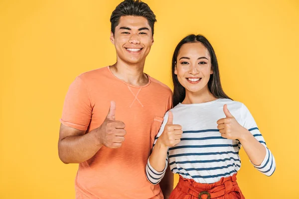 Cheerful Asian Couple Showing Thumbs While Smiling Camera Isolated Yellow — Stock Photo, Image