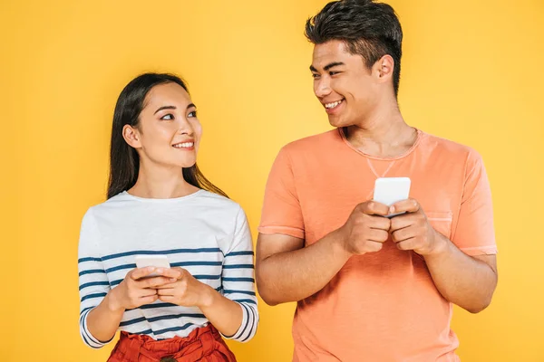 Cheerful Asian Man Woman Using Smartphones Looking Each Other Isolated — Stock Photo, Image